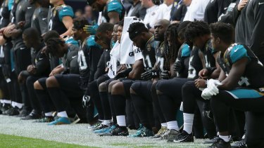 Jacksonville Jaguars players kneel during the playing of the US national anthem before an NFL football game against the Baltimore Ravens at Wembley Stadium in London on Sunday.
