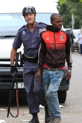 A young man is arrested for unknown reasons during a peace march against xenophobia in Durban on Thursday.
