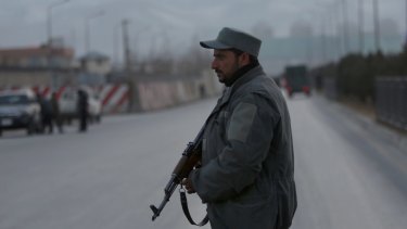 A member of the Afghan security forces stands guard near the site of two blasts in Kabul last month.