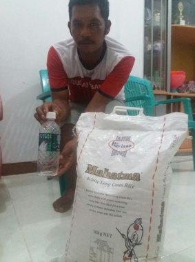 Fisherman Muhammad Hatta, who returned the asylum seekers to Indonesia, with rice and water 
provided by Australian authorities.