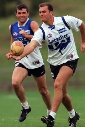 Stevens and Carey train as teammates at North Melbourne in 2000.
