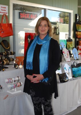 Jill James in front of her jewelry stall.