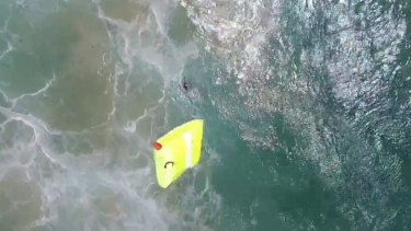 The drone dropped the flotation device to the swimmers. 