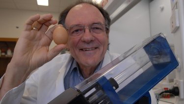 Professor Colin Raston with his invention, the vortex fluidic device, which can 'uncook' egg whites.