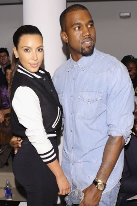 Slip of a smile: Kanye West (with wife Kim Kardashian) doesn't like smiling. 