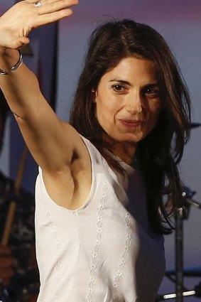 Virginia Raggi, of the 5-Star Movement, waves to supporters during a rally in Ostia, in the outskirts of Rome.