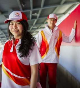 Tatsanee Benjaananpong, 25, and Chen Tang, 24, show off their volunteer uniforms for next year's Asian Cup at Canberra Stadium. 