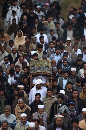 Execution: Villagers carry the body of executed militant and former soldier Arshad Mehmood to his grave.  