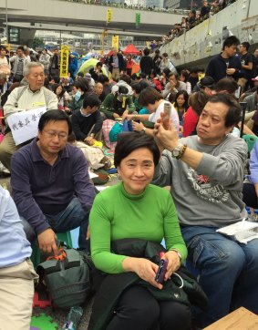 Hopeful: Democratic Party leader Emily Lau (in green) waits with other protesters to be arrested at their camp on Thursday.
