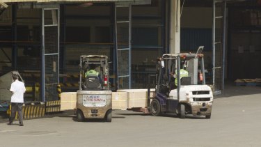 The coffins of Andrew Chan And Myuran Sukumaran on forklifts at Jakarta Airport.  