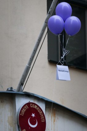 Balloons with a poster reading  "drop dead damned prostitute!" fly outside the Turkish embassy in Moscow.