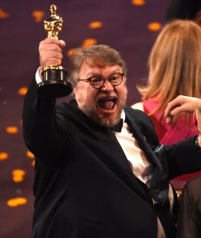 Guillermo del Toro, winner of the Oscar for best director for <i>The Shape of Water</i>, celebrates in the audience.