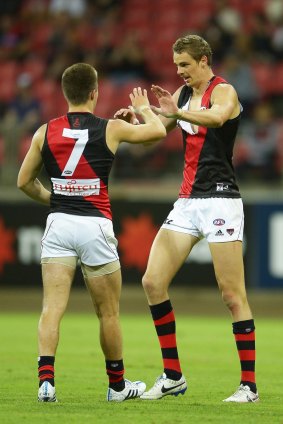 Joe Daniher (right), seen here celebrating a goal against GWS, has been charged with striking.