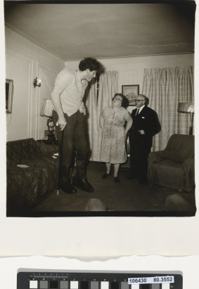 Diane Arbus, A Jewish giant at home with his parents in the Bronx, NY, 1970.