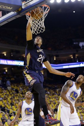 Get out of the way: New Orleans Pelicans forward Anthony Davis dunks near Golden State Warriors duo Leandro Barbosa and Andre Iguodala.