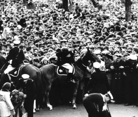 Police control crowds turning out for a glimpse of the Beatles in Melbourne in 1964.