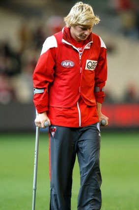 Heeney walks to the room on crutches.