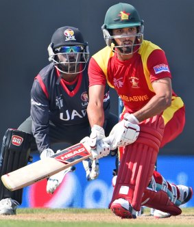 Zimbabwe batsman Sikandar Raza plays a ramp shot as UAE 'keeper Swapnil Patil looks on.