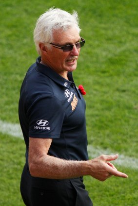 Mick Malthouse speaks to his bench during the match.