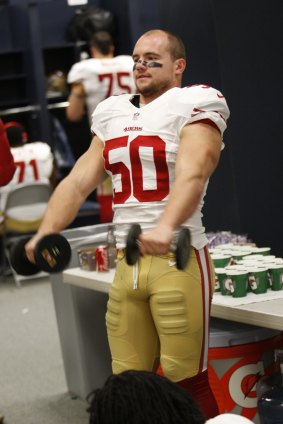 Chris Borland lifts weights in the locker room prior to the game against the Seattle Seahawks on December 14, 2014.