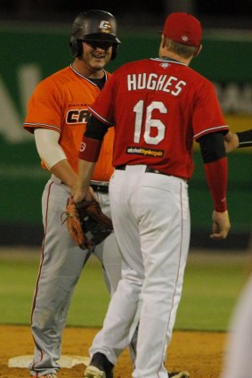Canberra Cavalry infielder Jason Sloan exchanges words with Perth Heat second-baseman Luke Hughes, which led to both benches clearing for some push-and-shove.
