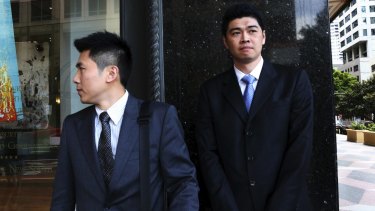 Perry Wu (right), who works for the company Green Time, leaving Downing Centre Court in 2015.