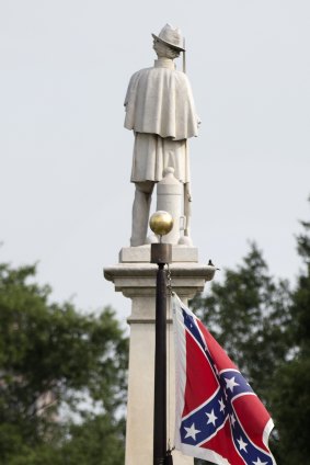 The Confederate battle flag flies next to a Civil War memorial outside the South Carolina state house.