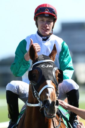 Jockey Rory Hutchings gives the thumbs up after riding Junoob to victory.