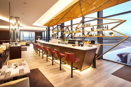 Planespotters get a prime view from the bar at 'The House' in Melbourne Airport's international terminal. 