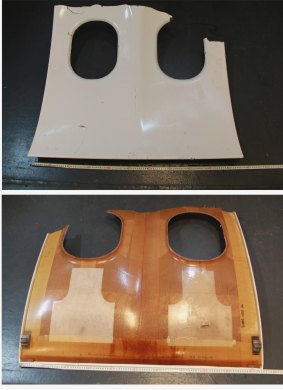 The front and reverse sides of debris resembling an aircraft window panel recovered by the Republic of Singapore Navy.