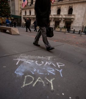"Fight Trump Every Day"? It won't happen on Wall Street as bankers walk past a protester's graffiti.