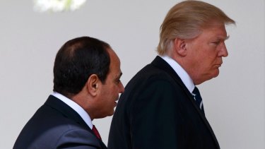 US President Donald Trump walks with Egyptian President Abdel Fattah al-Sisi in Washington. Sisi is grappling with the question of how to defeat a tenacious IS insurgency while also trying to fix a broken economy.