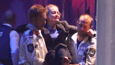 Police Rescue officers carry injured hostage Marcia Mikhael in Martin Place.