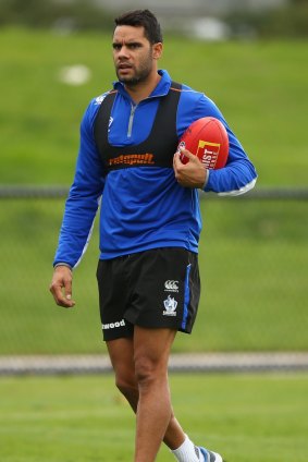 Wells looks on during a training session.