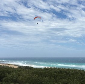 A paraglider at Fairhaven on the Surf Coast on Sunday. Twitter user @Allis.Jeff says this paraglider slammed into dunes seconds after the photo was taken.