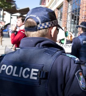 Queensland Police monitor protestors.