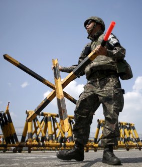 A South Korean soldier carries a barricade at a checkpoint on the Grand Unification Bridge, which leads to the truce village Panmunjom, where talks between North and South Korea are being held.