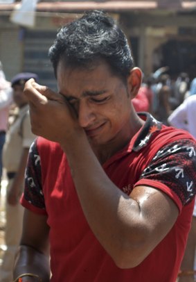 A relative of a victim of an explosion cries at the site of the incident in Madhya Pradesh.