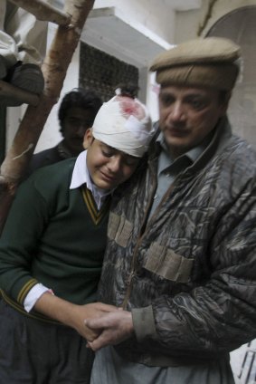 Student Mohammad Baqir is comforted by his uncle after learning that his mother, a teacher at the school, was killed.