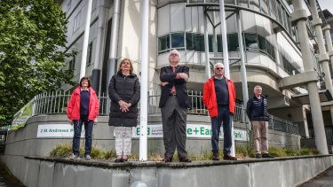 Stuart Hamilton, centre, and East Melbourne residents who are campaigning to stop the state government selling the former Peter MacCallum cancer hospital site. 