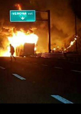 Flames engulf a bus that crashed near Verona, northern Italy.
