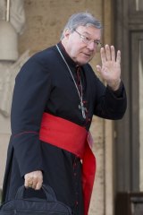 Cardinal George Pell arrives for a morning session at the Vatican.