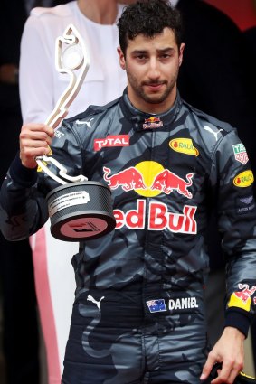 Ricciardo looking as though he wants to throw the second-place trophy at someone.