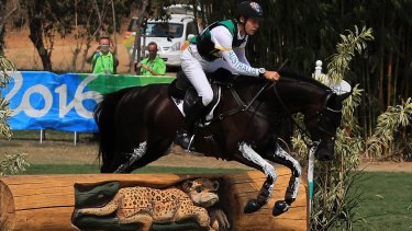 Christopher Burton of Australia riding Santano II clears a jump during the Cross Country Eventing.