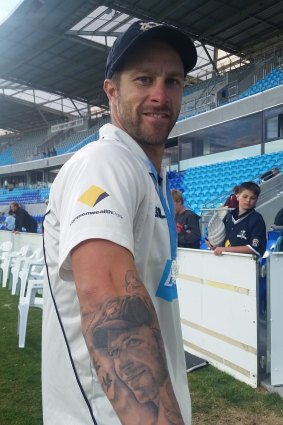 Victoria wicketkeeper Matthew Wade proudly shows his tattoo, a tribute to late teammate Phillip Hughes, soon after his team won the 2014-15 Sheffield Shield title at Hobart's Blundstone Arena against Western Australia.