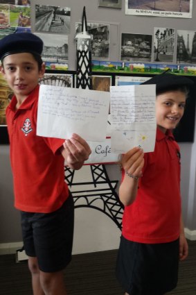 Aranda Primary School year 4 students Theodore Manikis, 10, and Annika Connelly-Hansen, 9, are keeping in touch with French pen pals using the old fashioned method.