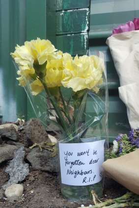 Flowers at the scene of a factory fire where three squatters died on March 1.