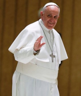 Pope Francis waves to the faithful at the Vatican.