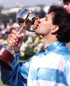 Priceless: Rogan Josh's rider, John Marshall. kisses the famous trophy.