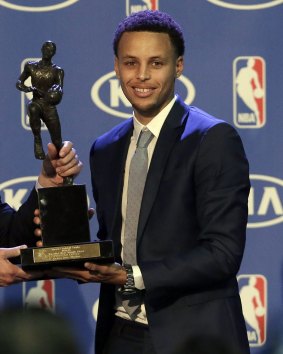 Curry poses with the trophy on Monday.